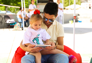Father reading a book to his daughter  Credit: Liridon Qorraj