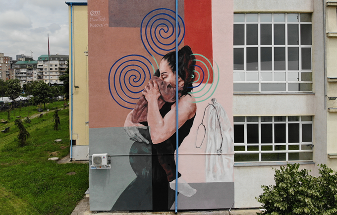 A mural depicting a pregnant woman holding a child
