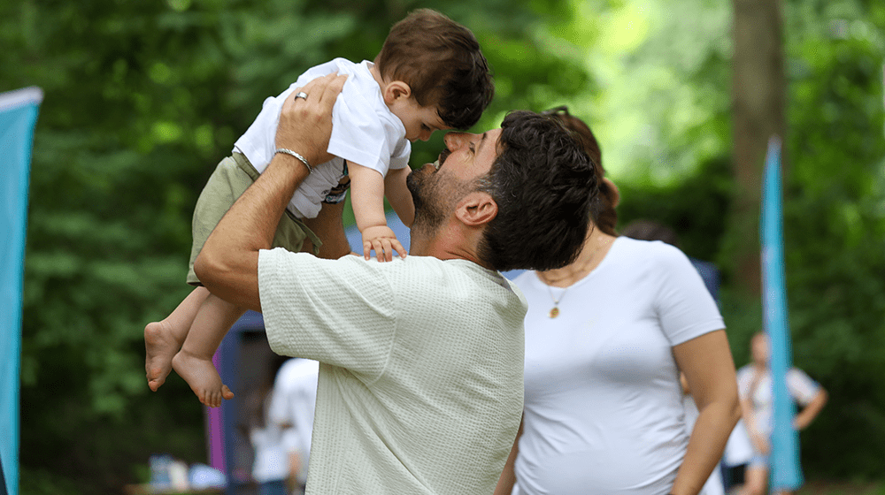 A dad lifting up a kid