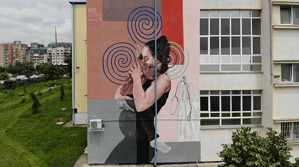 A mural depicting a pregnant woman holding a child